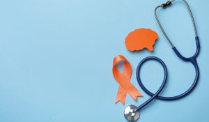 Orange ribbon, stethoscope and paper brain cutout on light blue background, flat lay with space for text. Multiple sclerosis awareness