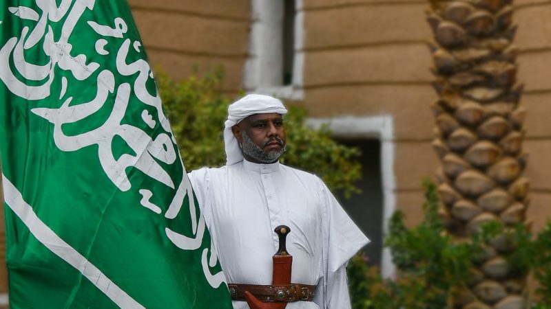 Man holding Saudi Arabia flag