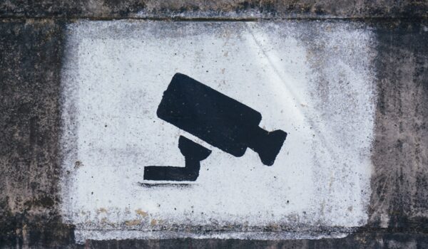Black and white drawing of surveillance camera on concrete wall