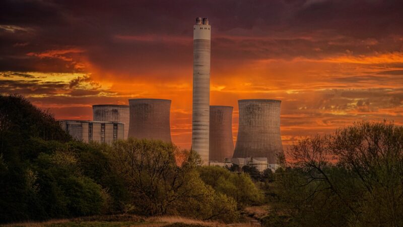 Power plant with orange sky in background