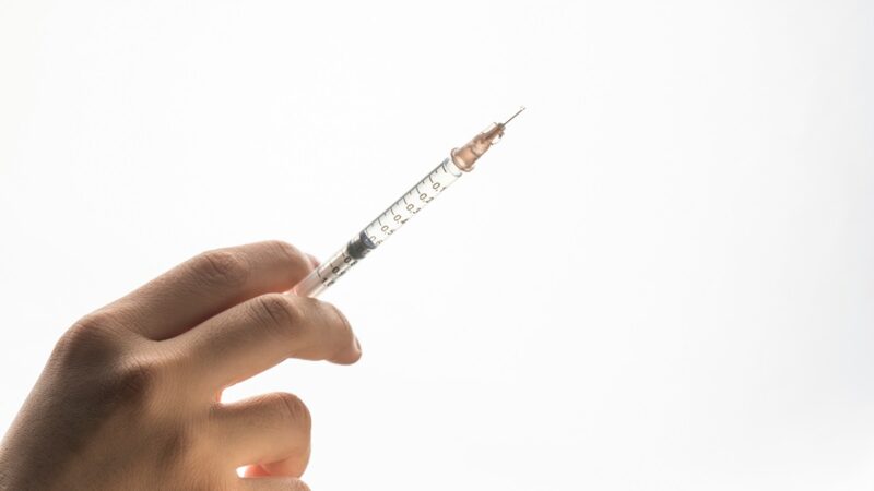 Syringe in hand