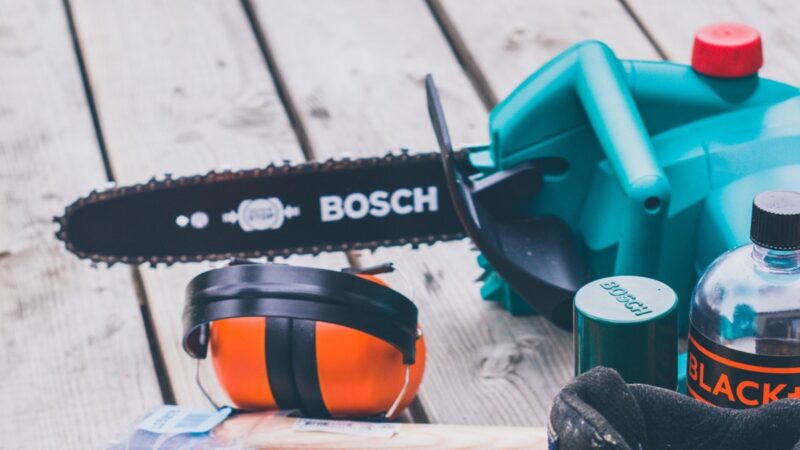 Bosch chainsaw and other work gear on a deck