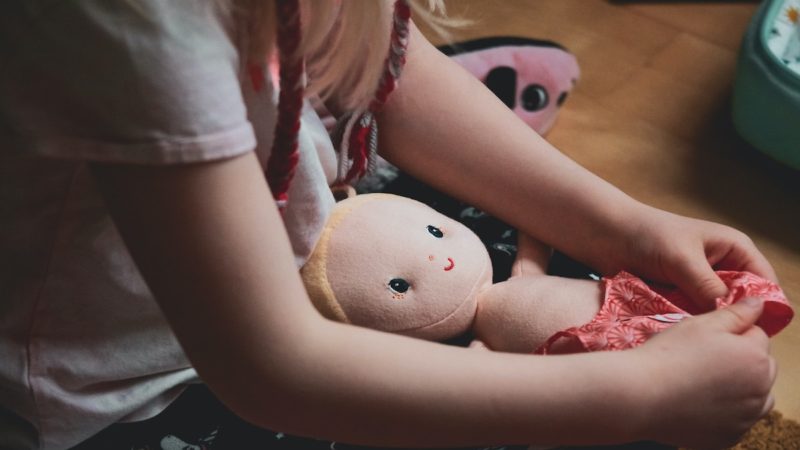 Child playing with doll