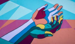 Mural of two hands holding one another