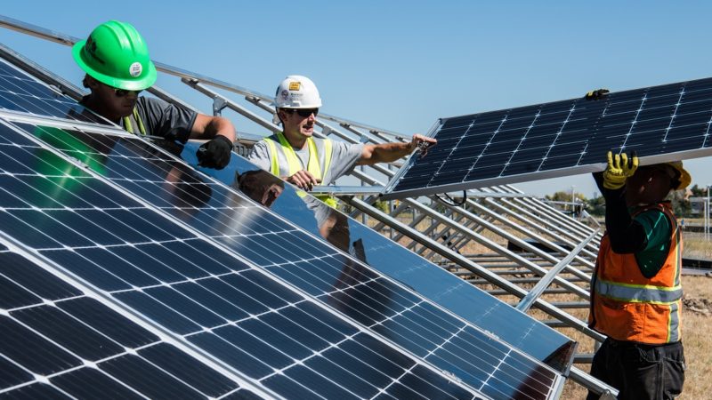 Workers installing solar panels