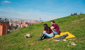 Couple sitting on a hillside in Spain