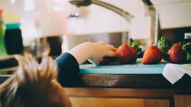 Child taking a strawberry