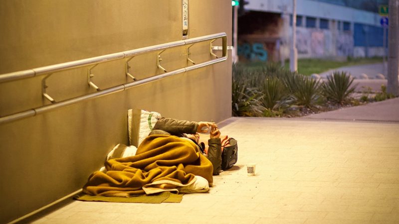 Homeless person lying on the ground