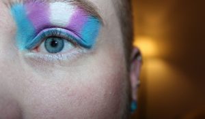 Person with trans flag eye shadow