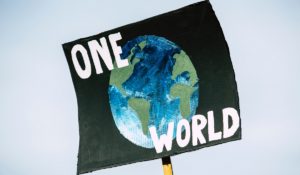 "One World" protest sign