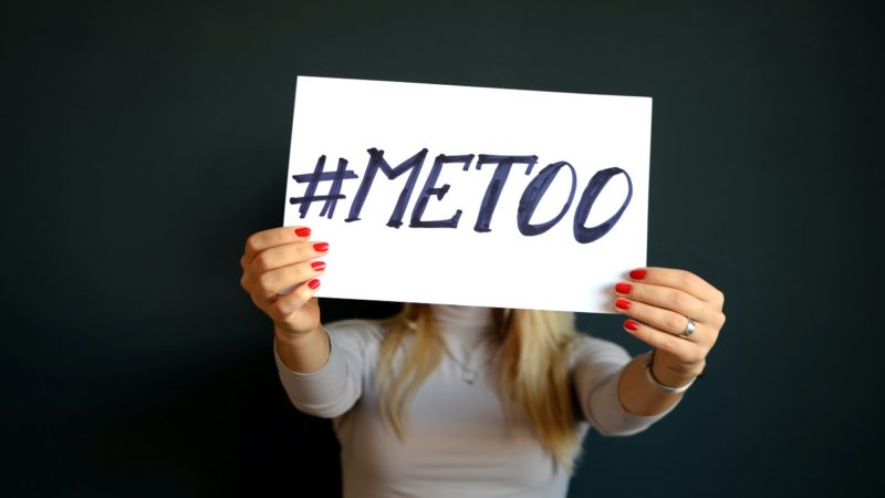 A woman show "Me too" hastag sign