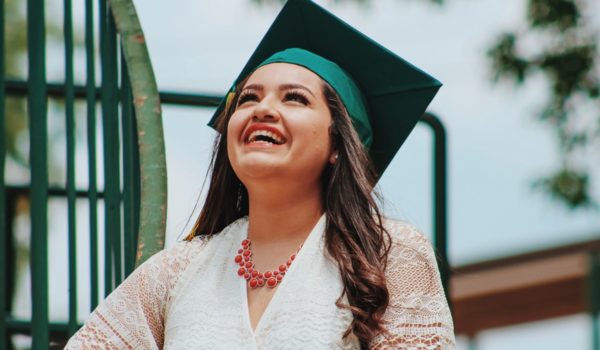 Woman in graduation garb smiling