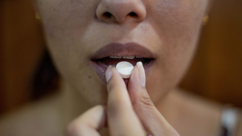 Woman eating pill