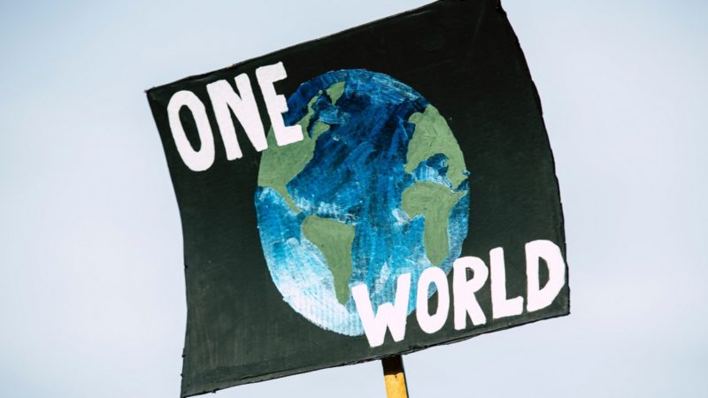 "One World" sign