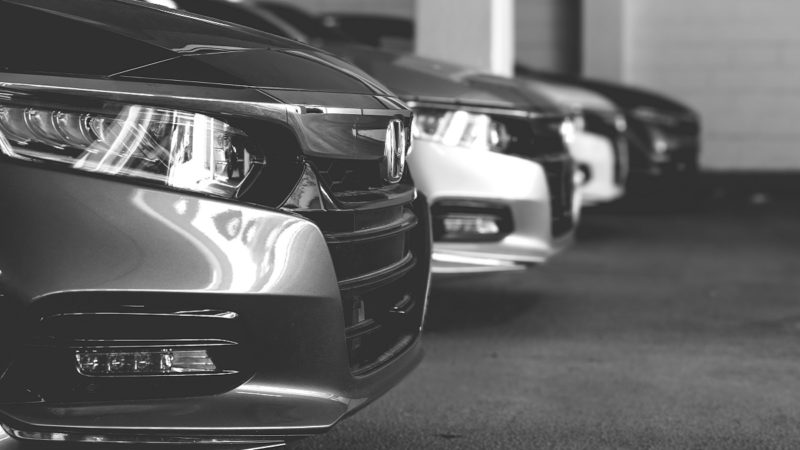 Black and white photo of a row of Honda Accords