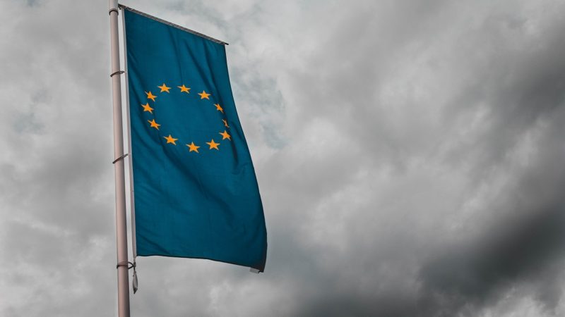 EU flag against overcast sky