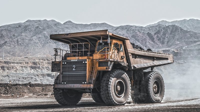 Mining dump truck in arid landscape