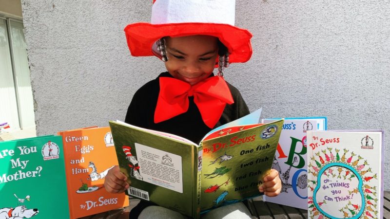 Child reading Dr. Seuss books