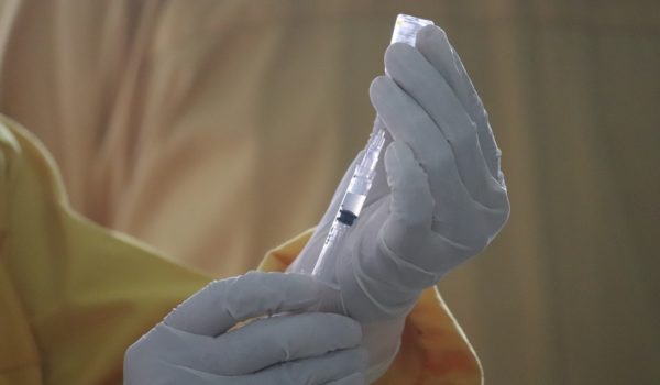Readying a vaccine syringe