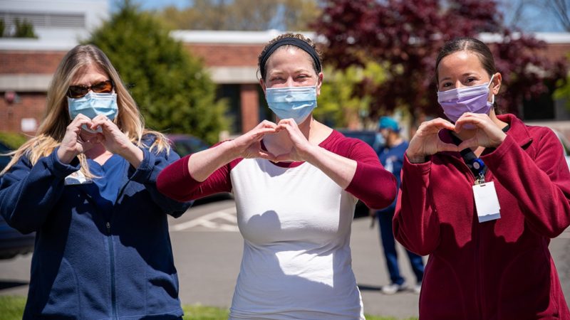 Healthcare workers making heart sign with hands