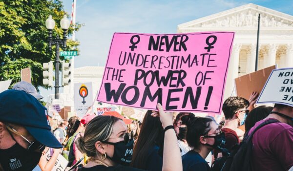 "Never underestimate the power of women" sign