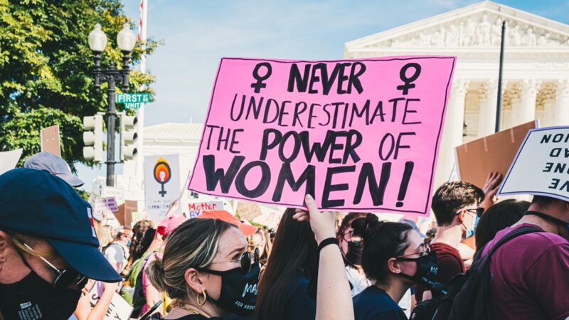"Never underestimate the power of women" sign