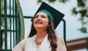 Woman with graduation cap smiling