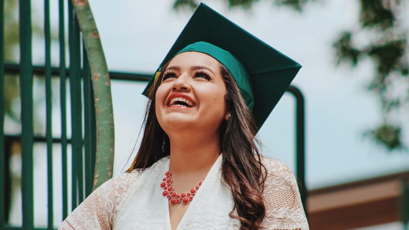 Woman with graduation cap smiling