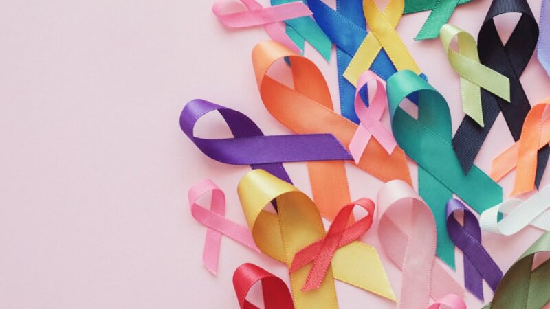 Colorful ribbons on pink background