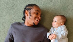 Father and baby smiling